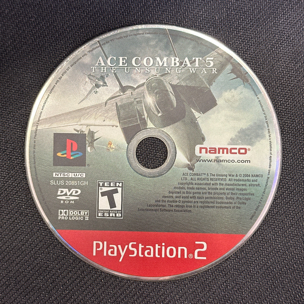 PlayStation 2 game disc for 'Ace Combat 5' on a dark textured background
