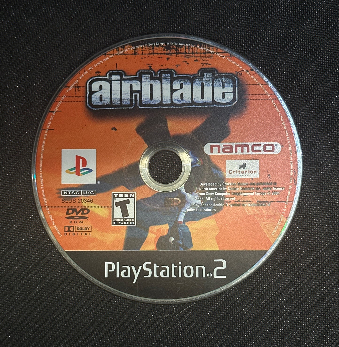 PlayStation 2 game disc with 'airblade' and 'namco' branding on a black background