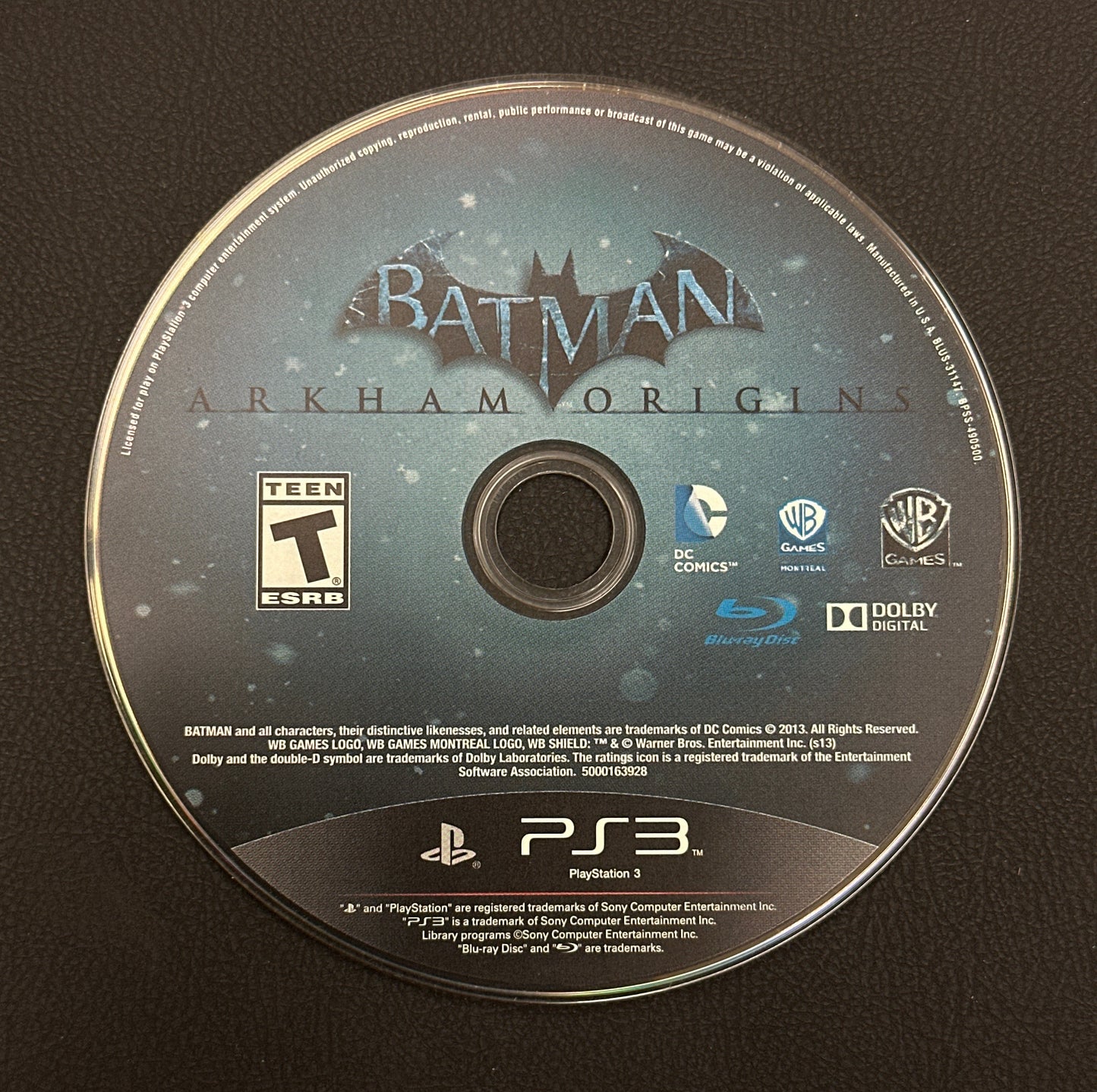 Batman: Arkham Origins game disc on a black background