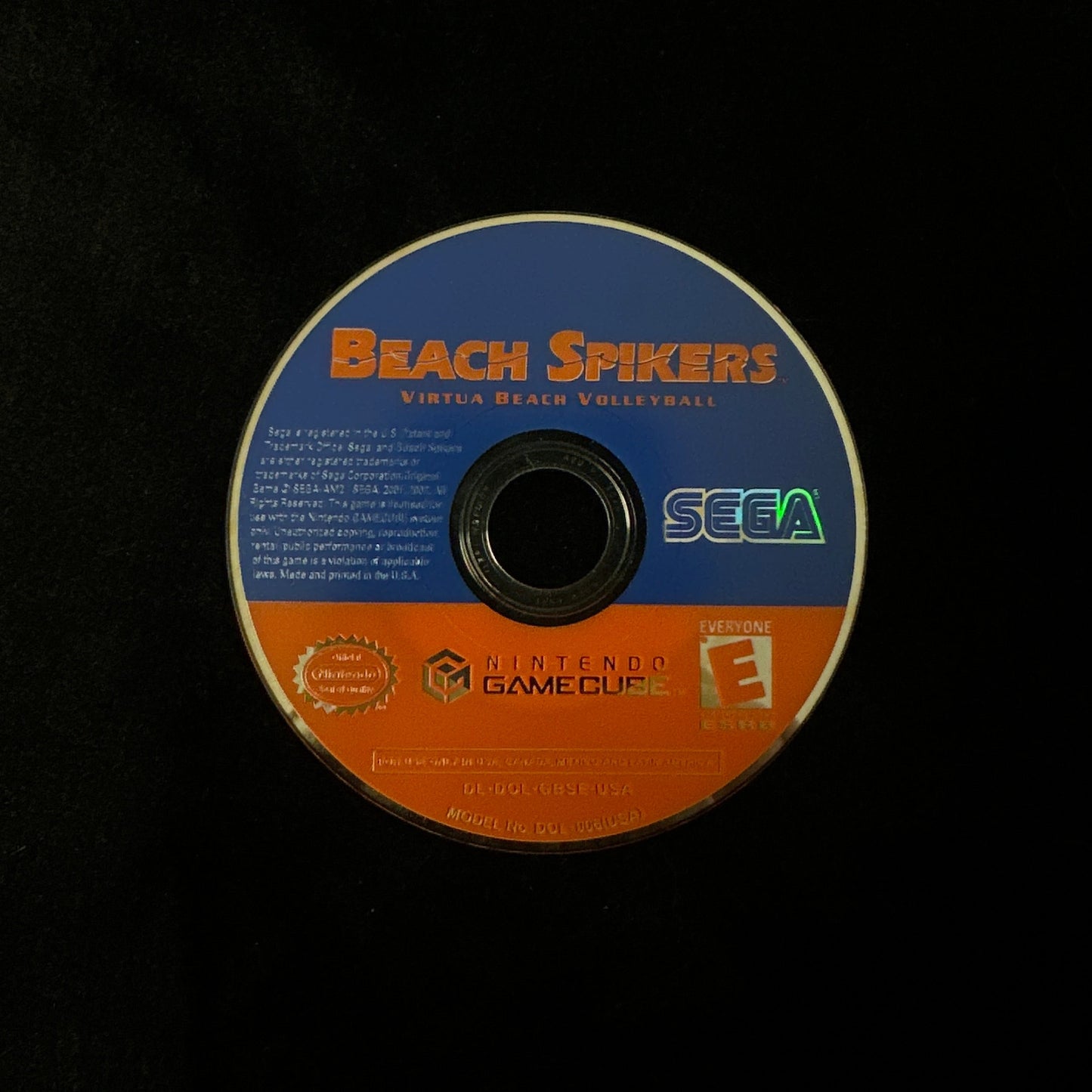 Nintendo GameCube game disc for 'Beach Spikers' featuring a blue and orange label with the SEGA logo, photographed on a black background.