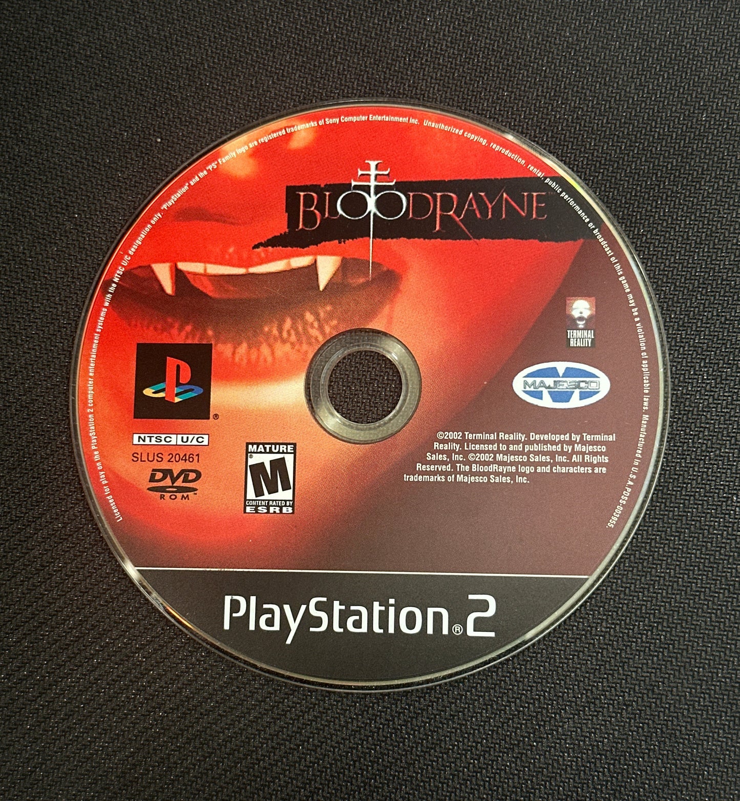 PlayStation 2 game disc with 'BloodRayne' on a black textured background