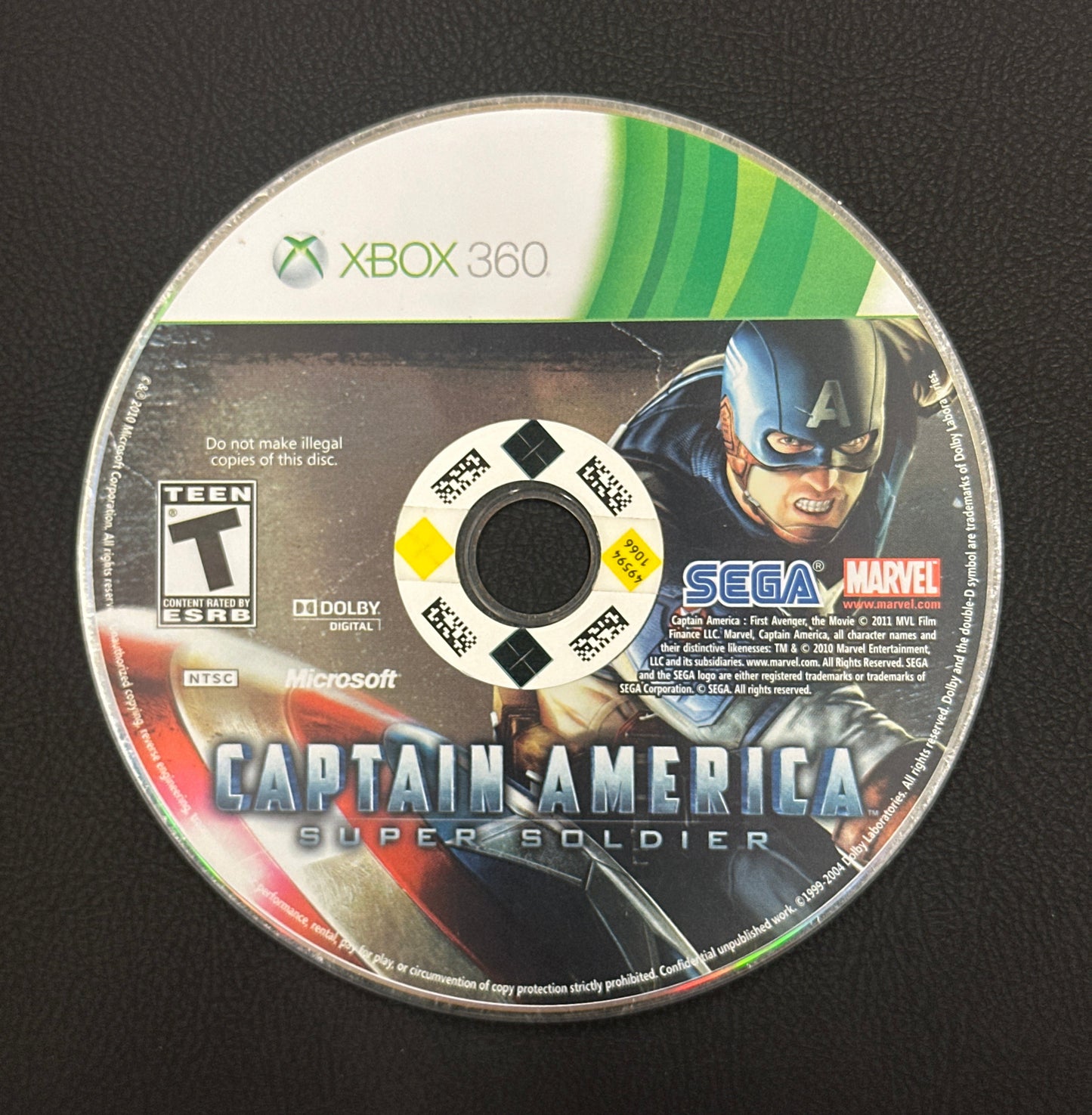 Game disc for 'Captain America: Super Soldier' on Xbox 360 with branding and graphics.