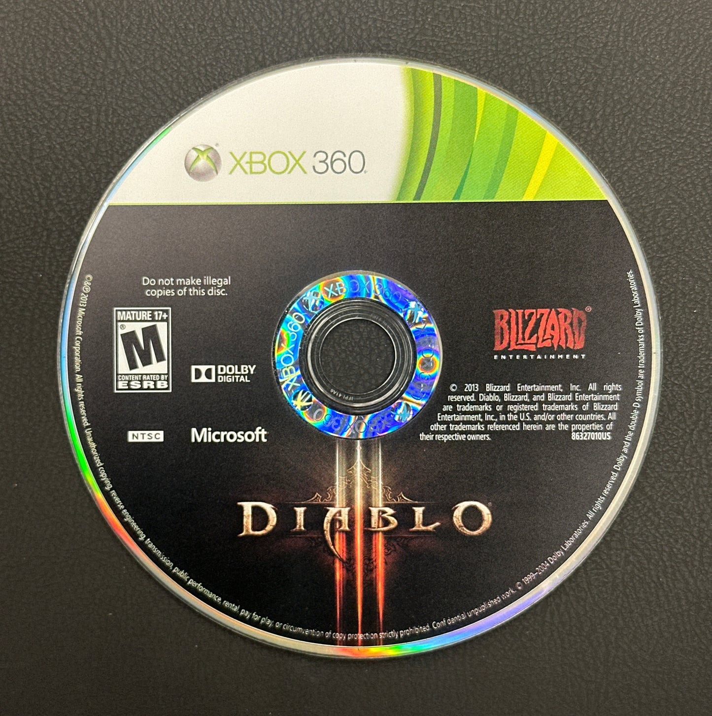 Game disc for 'Diablo' on Xbox 360 with Microsoft and Blizzard branding on a black background