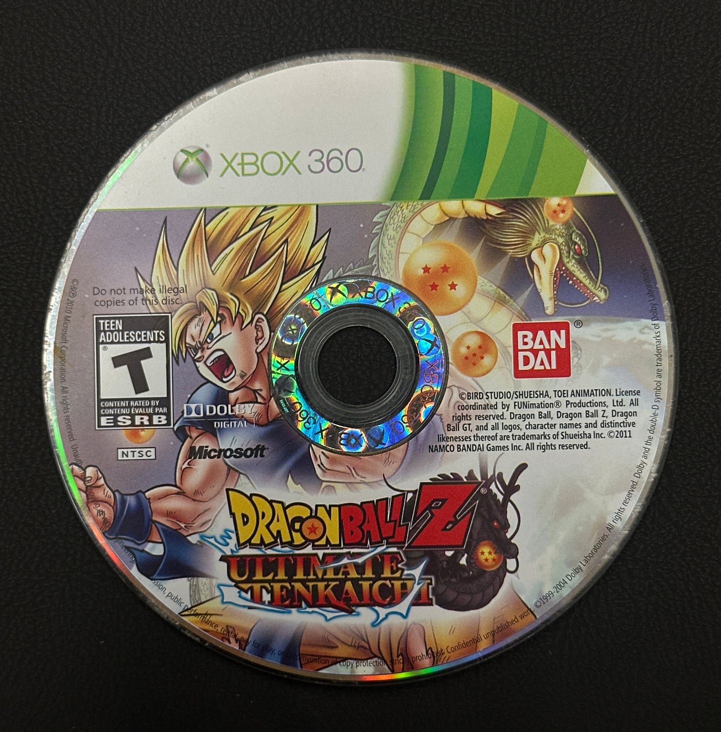 Dragon Ball Z Ultimate Tenkaichi game disc for Xbox 360 on a black background