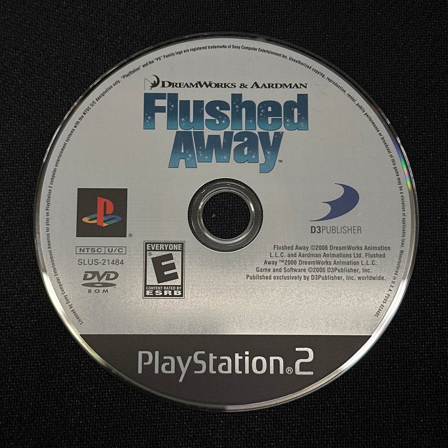 PlayStation 2 game disc for 'Flushed Away' on a black background