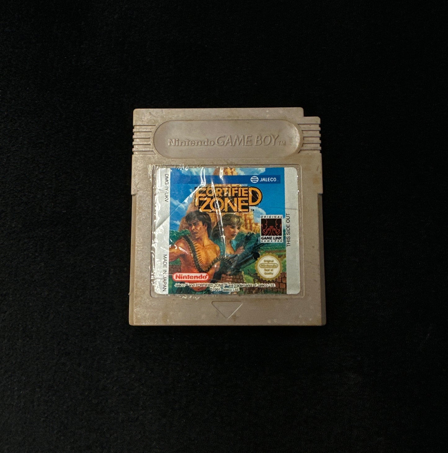 Game cartridge with a label on a black background