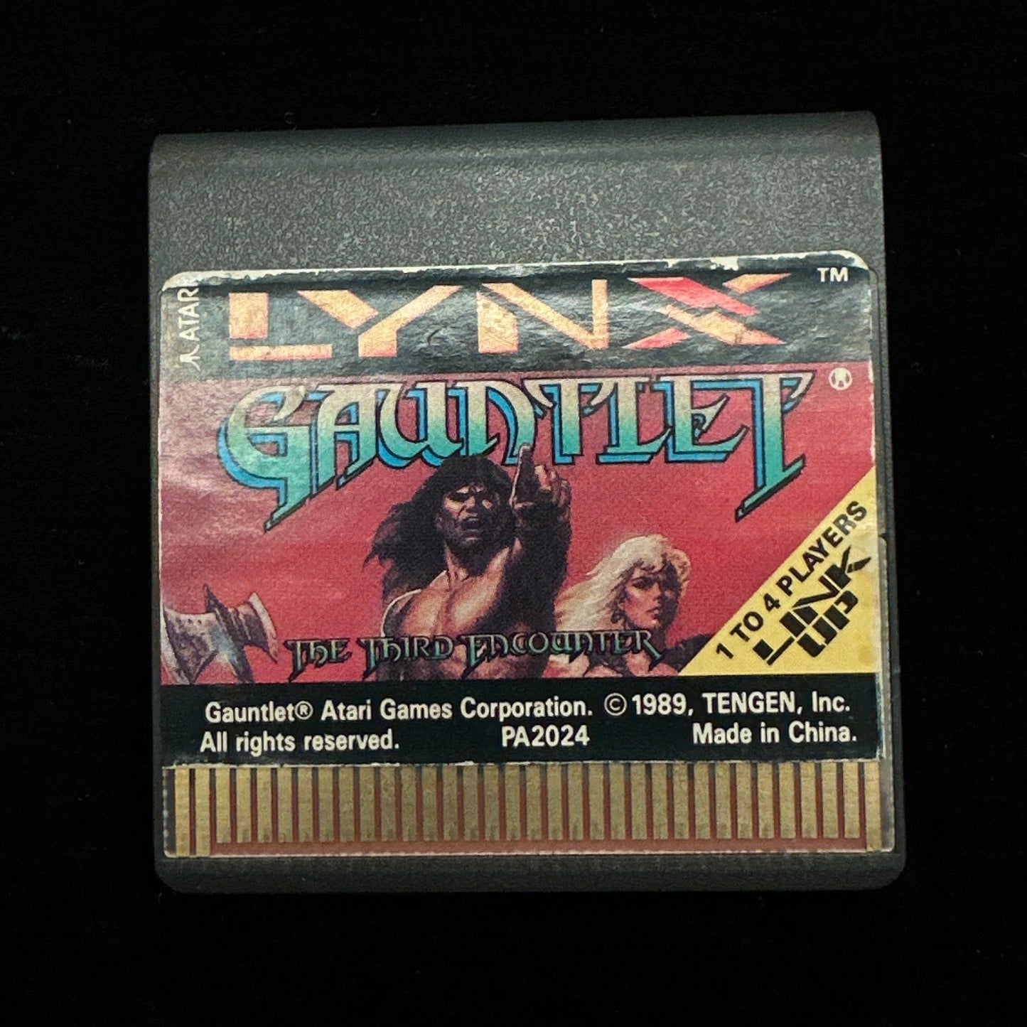 Vintage video game cartridge with colorful label on a black background