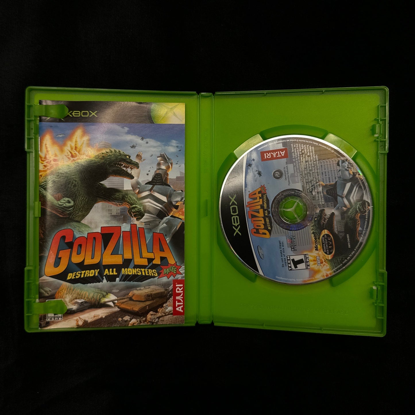 Xbox game disc and cover with 'Godzilla' artwork on a black background