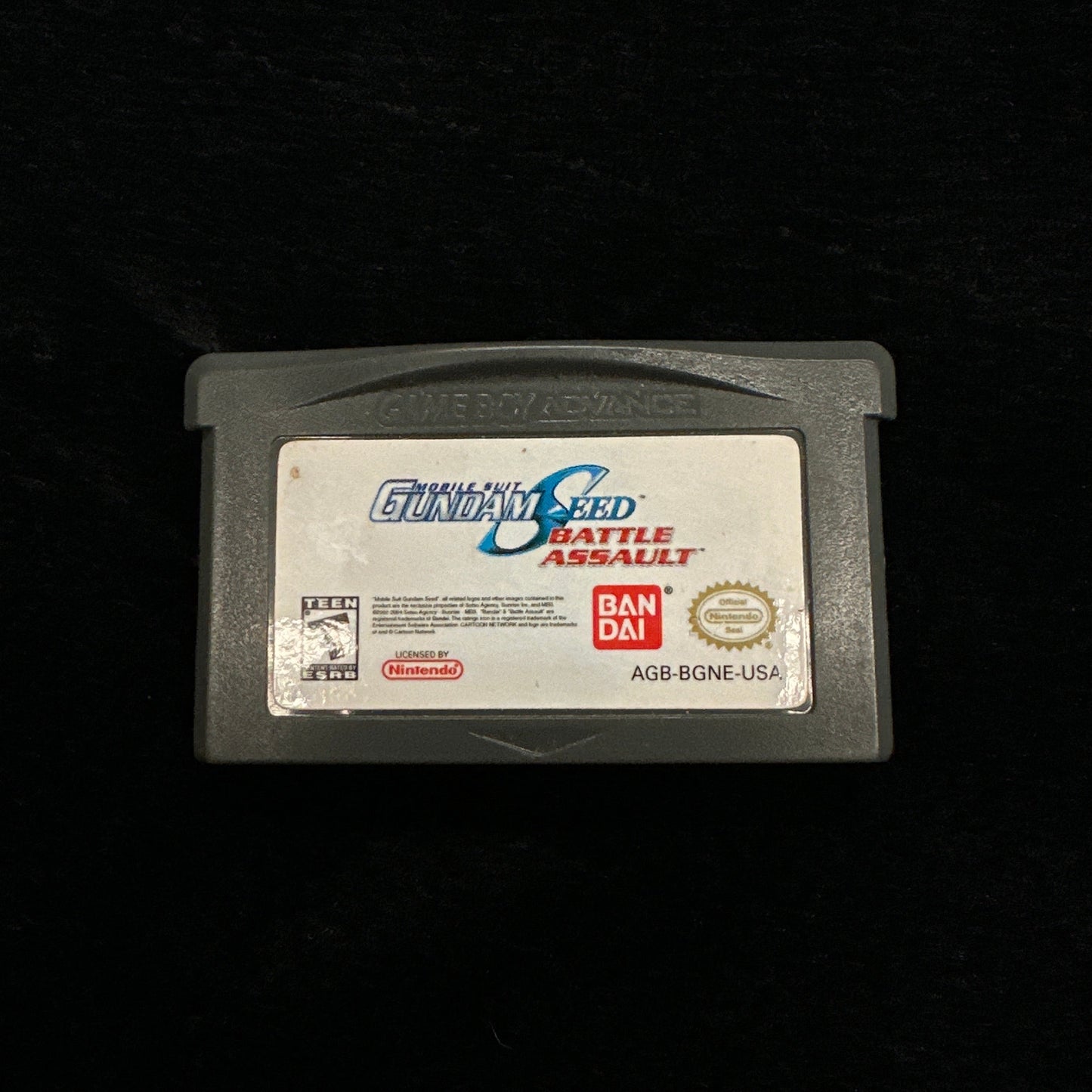 Game cartridge with branding on a black background