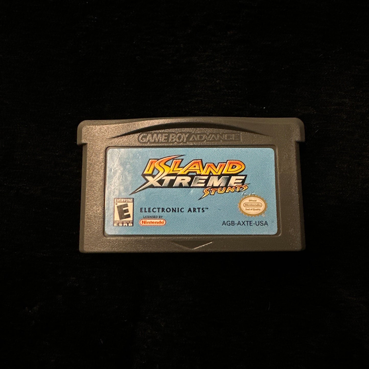 Game cartridge with 'Island Xtreme' branding on a black background