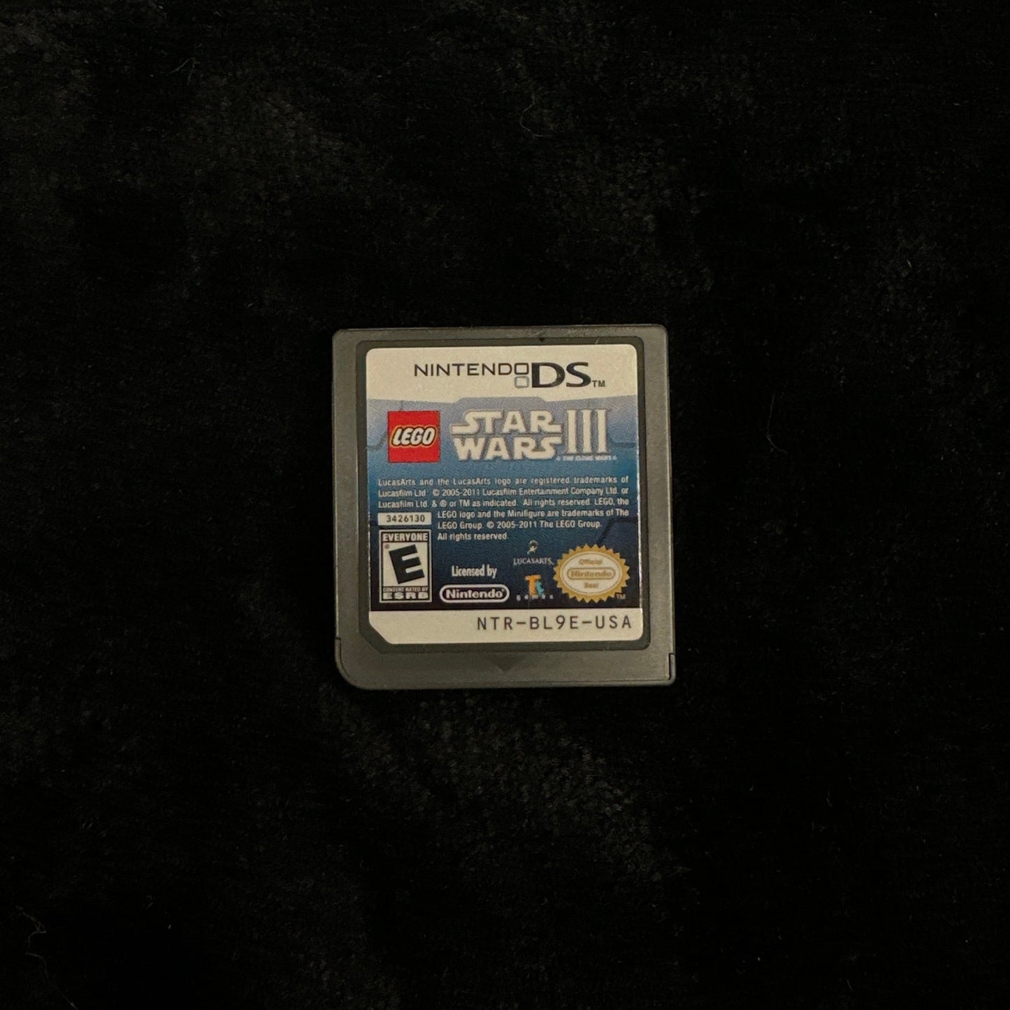 Nintendo DS game cartridge on a dark textured surface