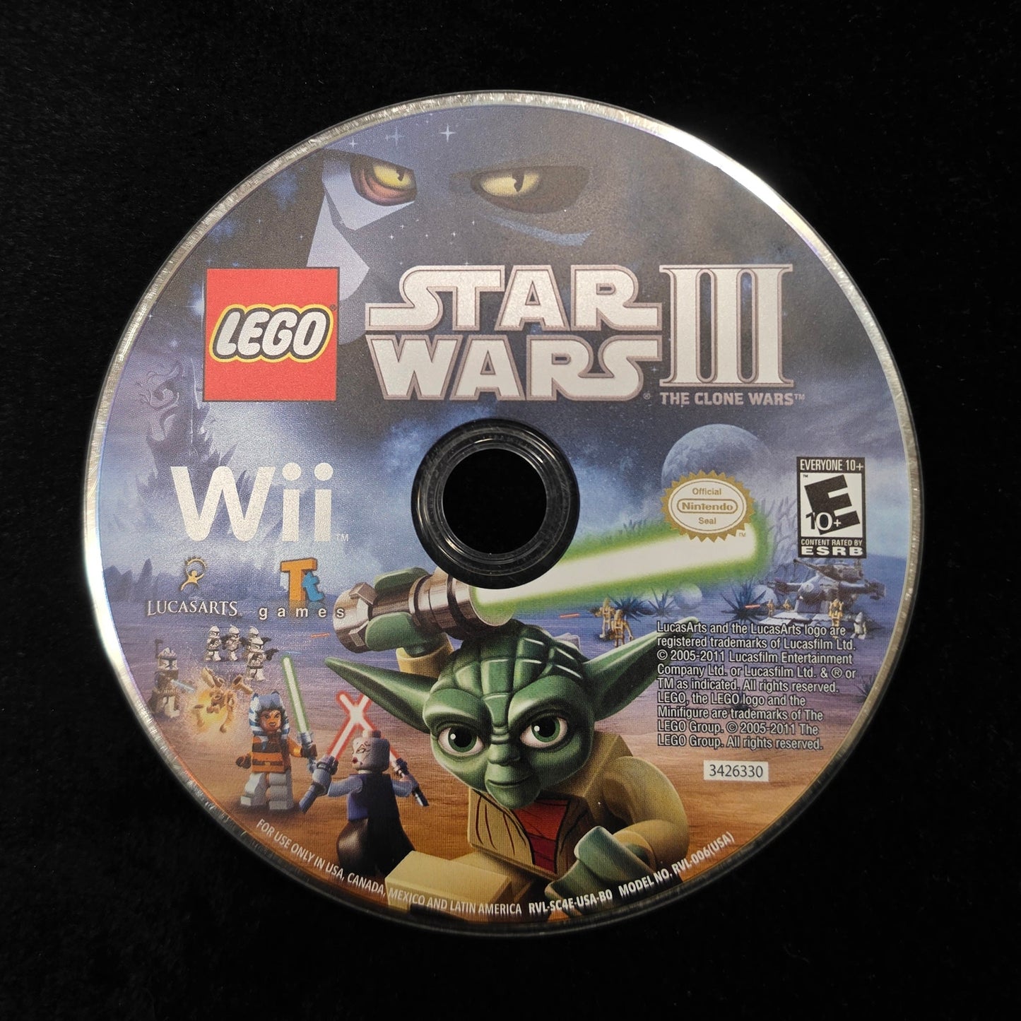 A LEGO Star Wars III Wii game disc resting on a black surface, showing Yoda and other game artwork on the label.