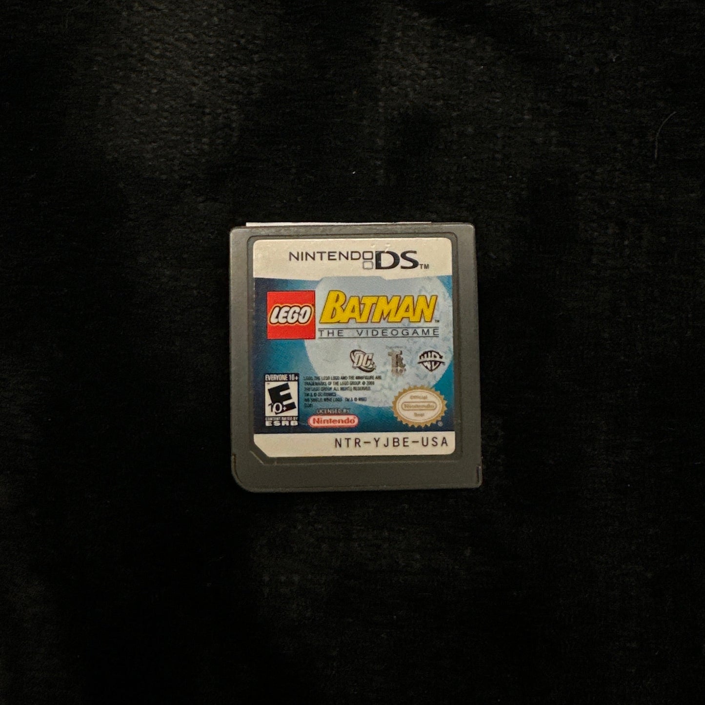 Game cartridge for a handheld gaming console on a dark background