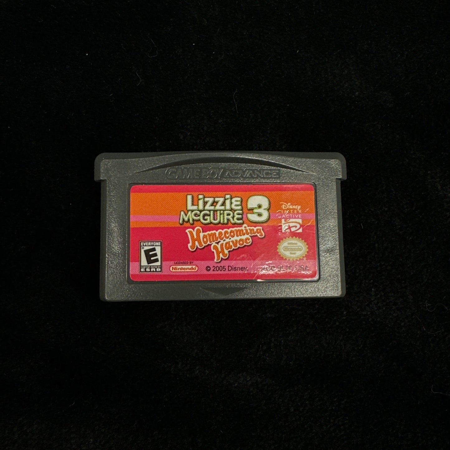 Game cartridge with a colorful label on a black background