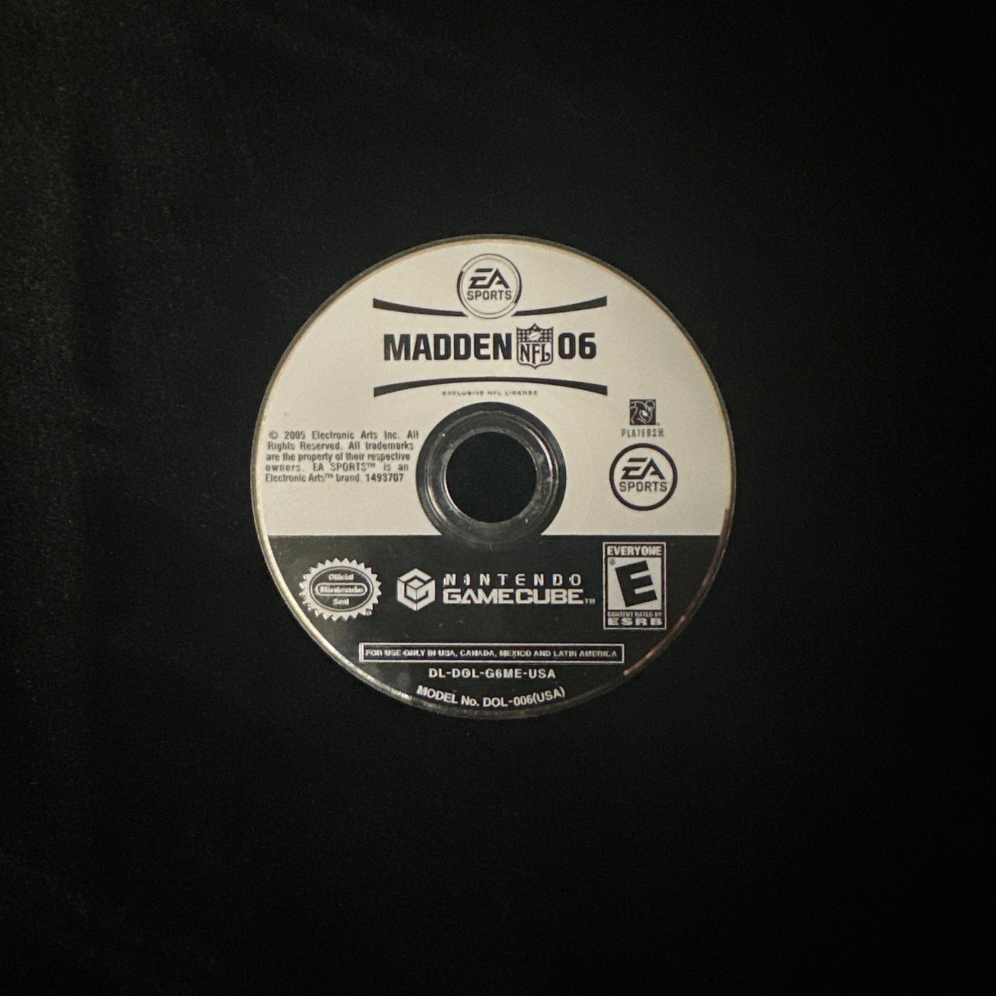 A single PlayStation 2 game disc for Madden 06 on a black background.