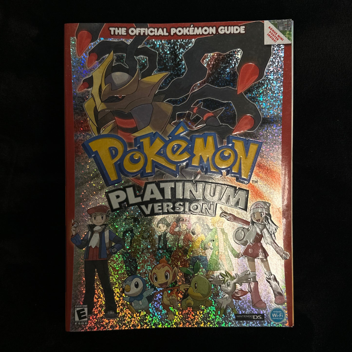 Pokémon guide book titled 'Pokémon Platinum Version' held by a person.