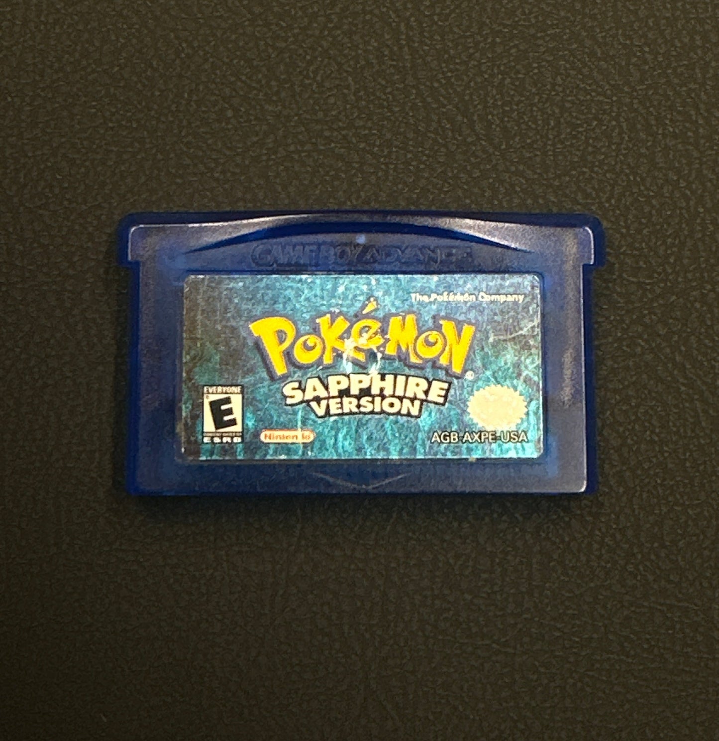 Pokémon Sapphire Version game cartridge on a dark background