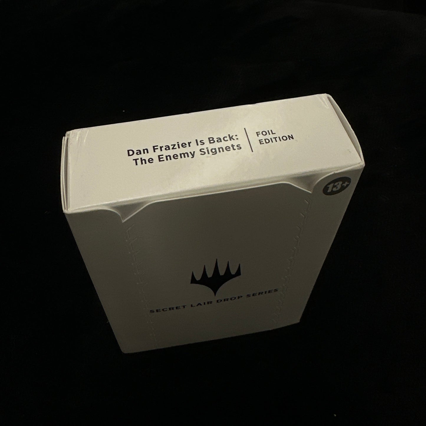 Product packaging with mtg logo on a dark background