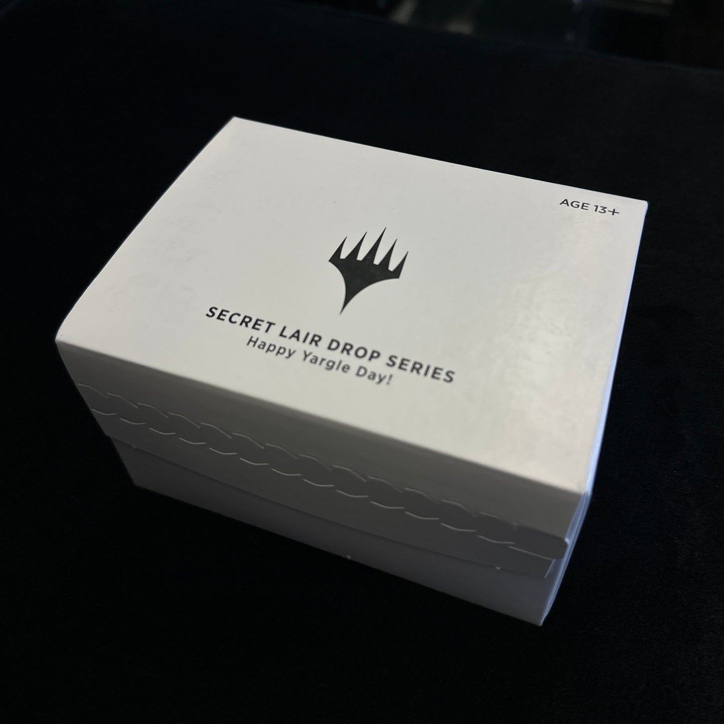 White box with Mtg logo and text on a black background