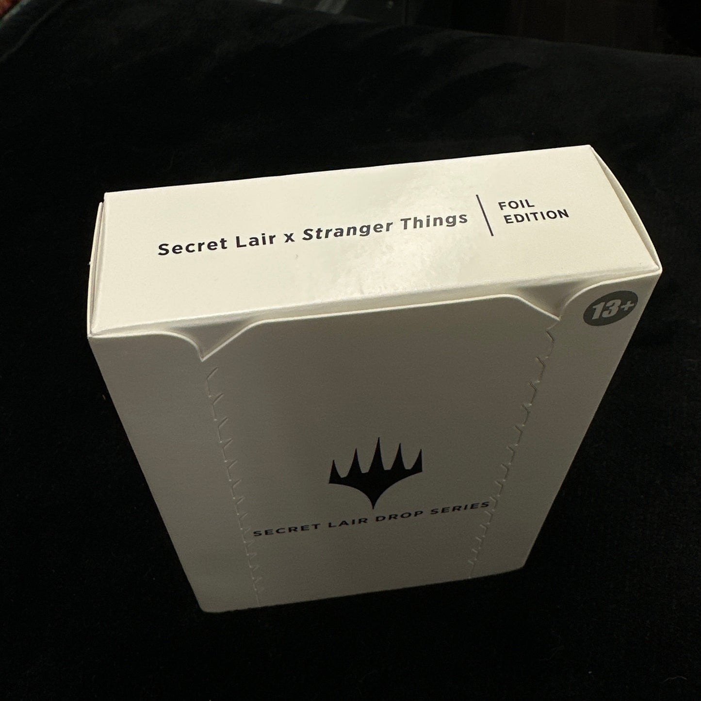 White box with 'Secret Lair & Stranger Things' text on a black background