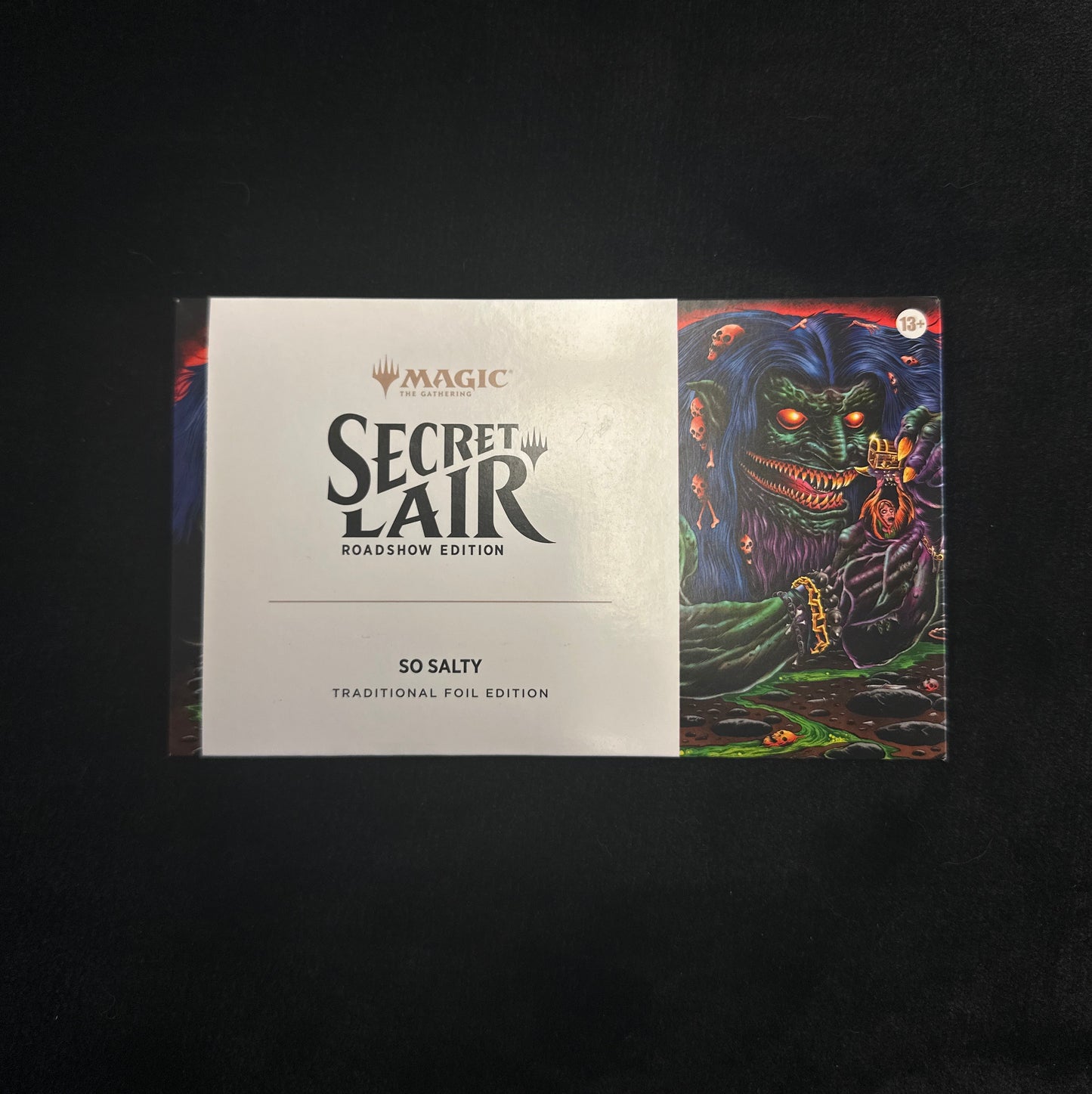 Card game box titled 'Secret Lair' with colorful artwork on a black background