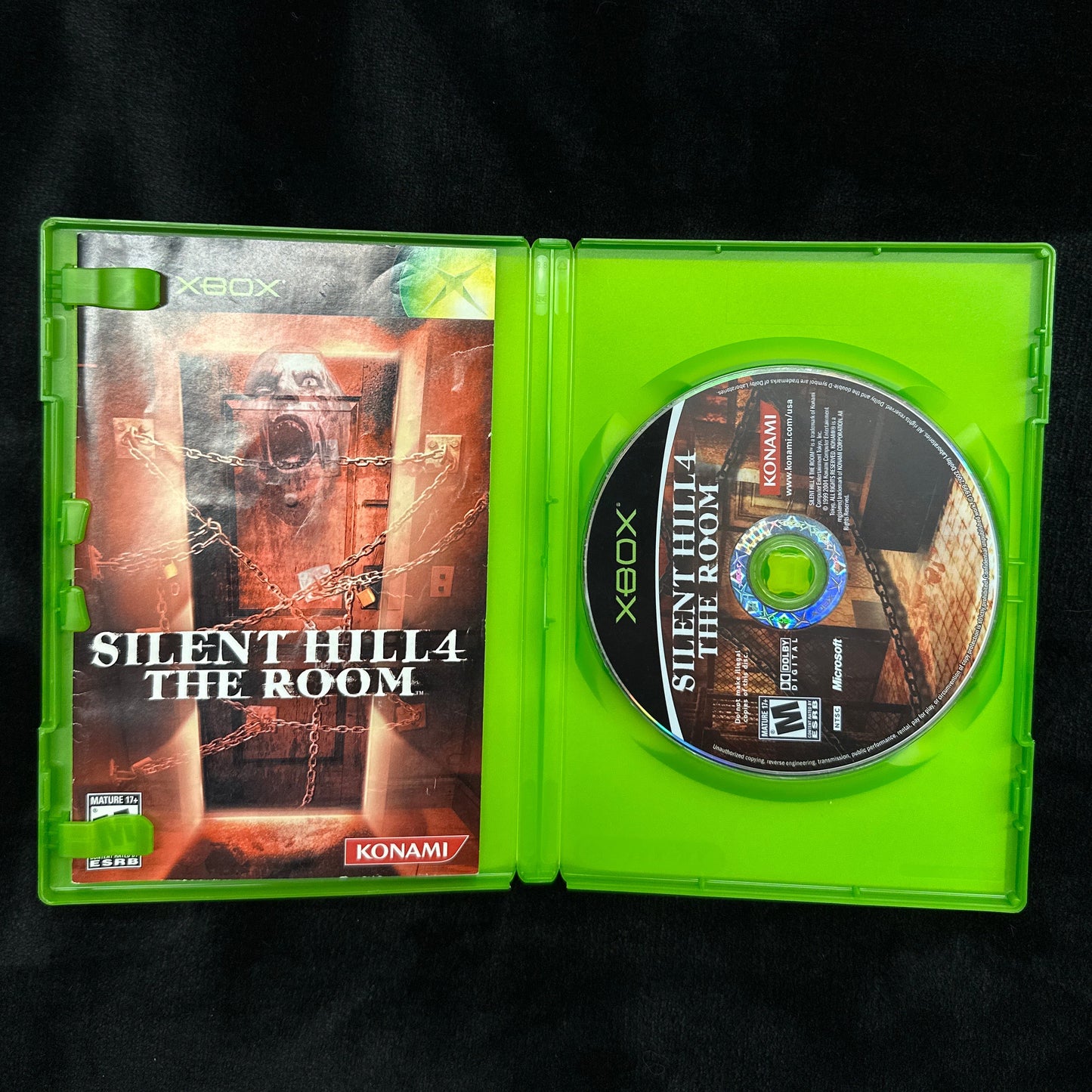 Xbox game disc and case titled 'Silent Hill: The Room' on a black background