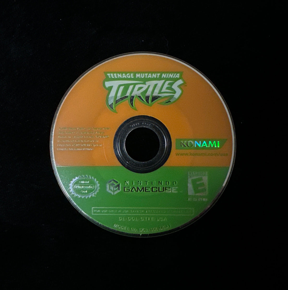 A Teenage Mutant Ninja Turtles video game disc for the Nintendo GameCube, featuring an orange and green label design, photographed on a black background.