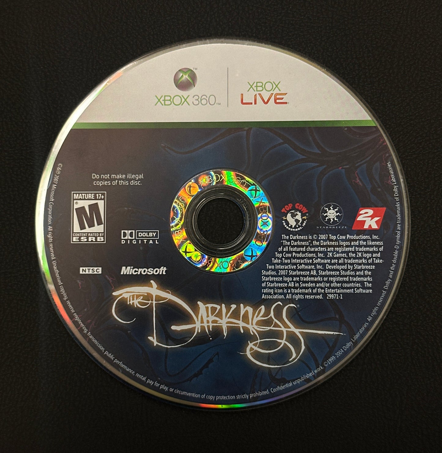 Game disc with Xbox Live and Microsoft branding on a black background
