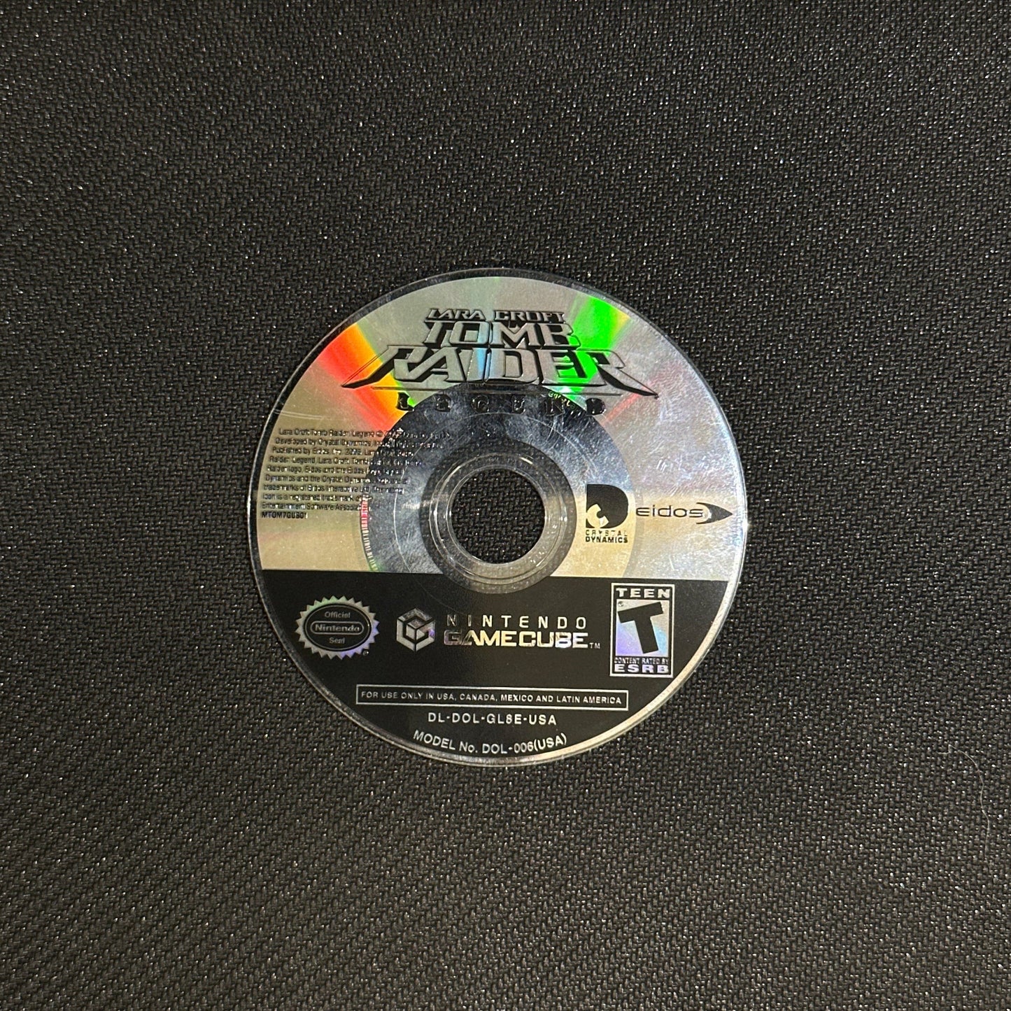 Game disc with label on a textured black surface