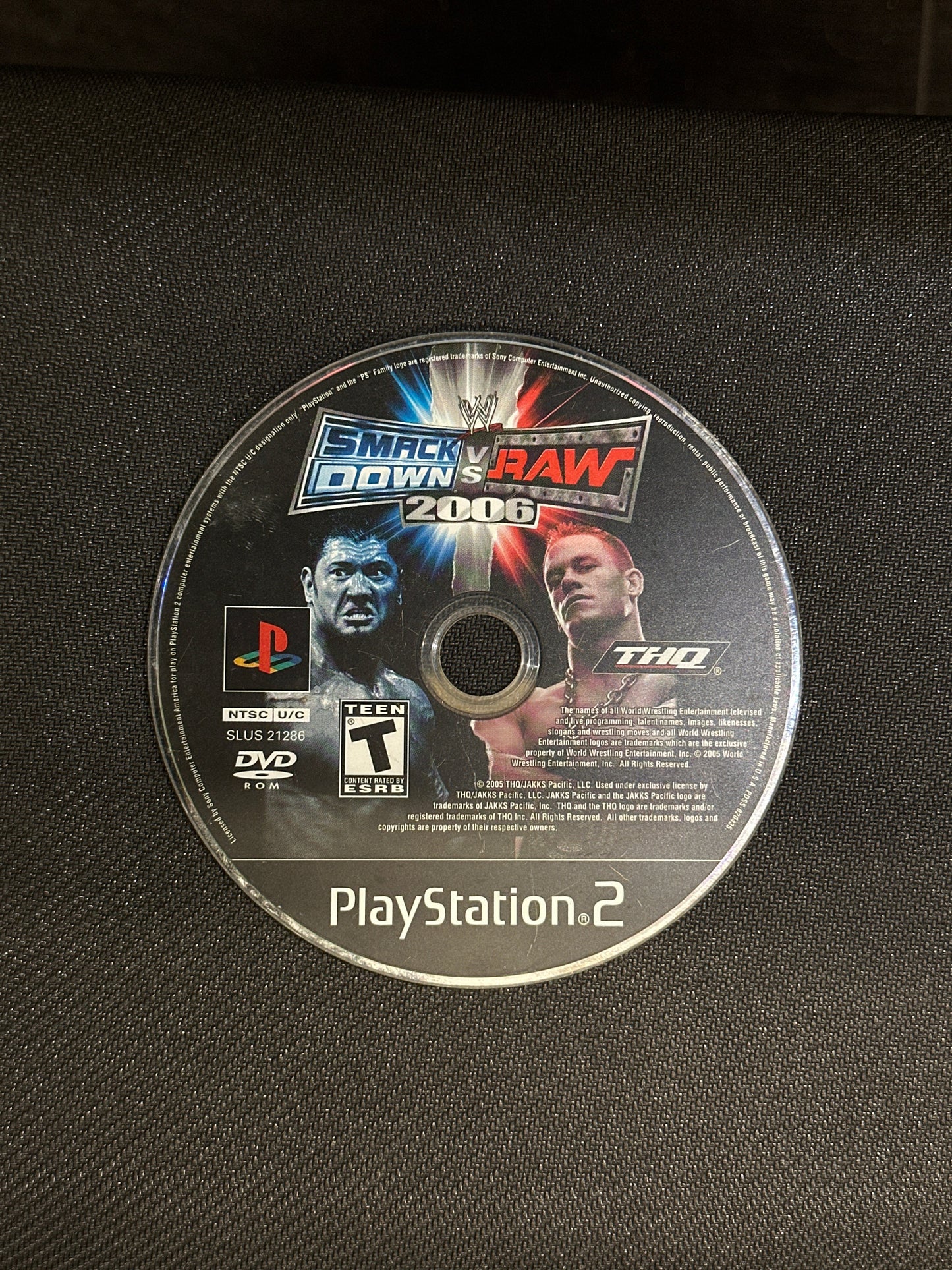 Wrestling game disc for PlayStation 2 on a textured black surface