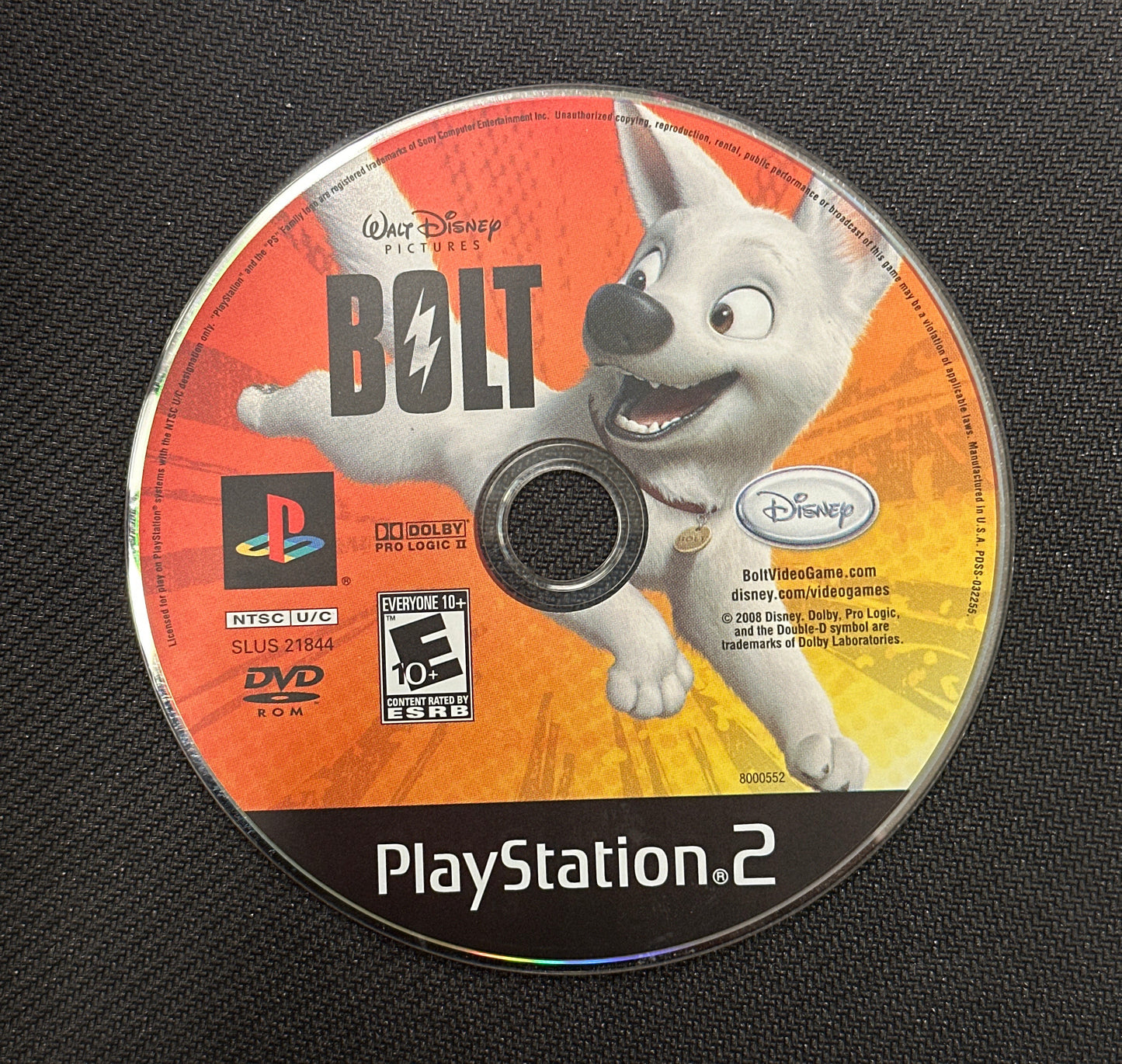 PlayStation 2 game disc for 'Bolt' on a textured black surface