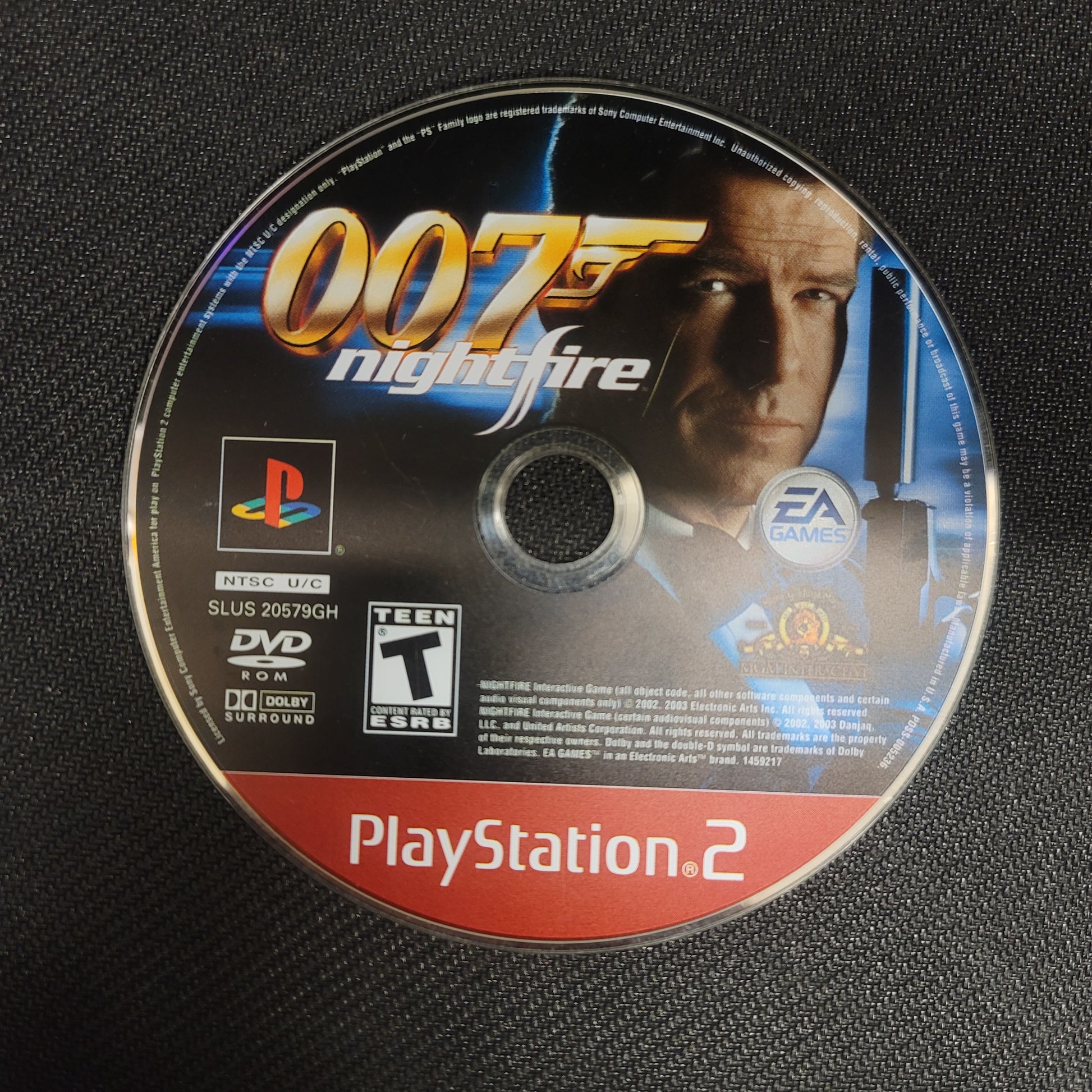 PlayStation 2 game disc for '007: Nightfire' on a black textured background