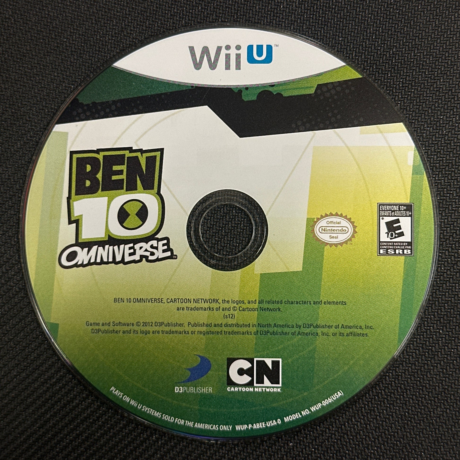 Ben 10 Omniverse game disc on a black surface