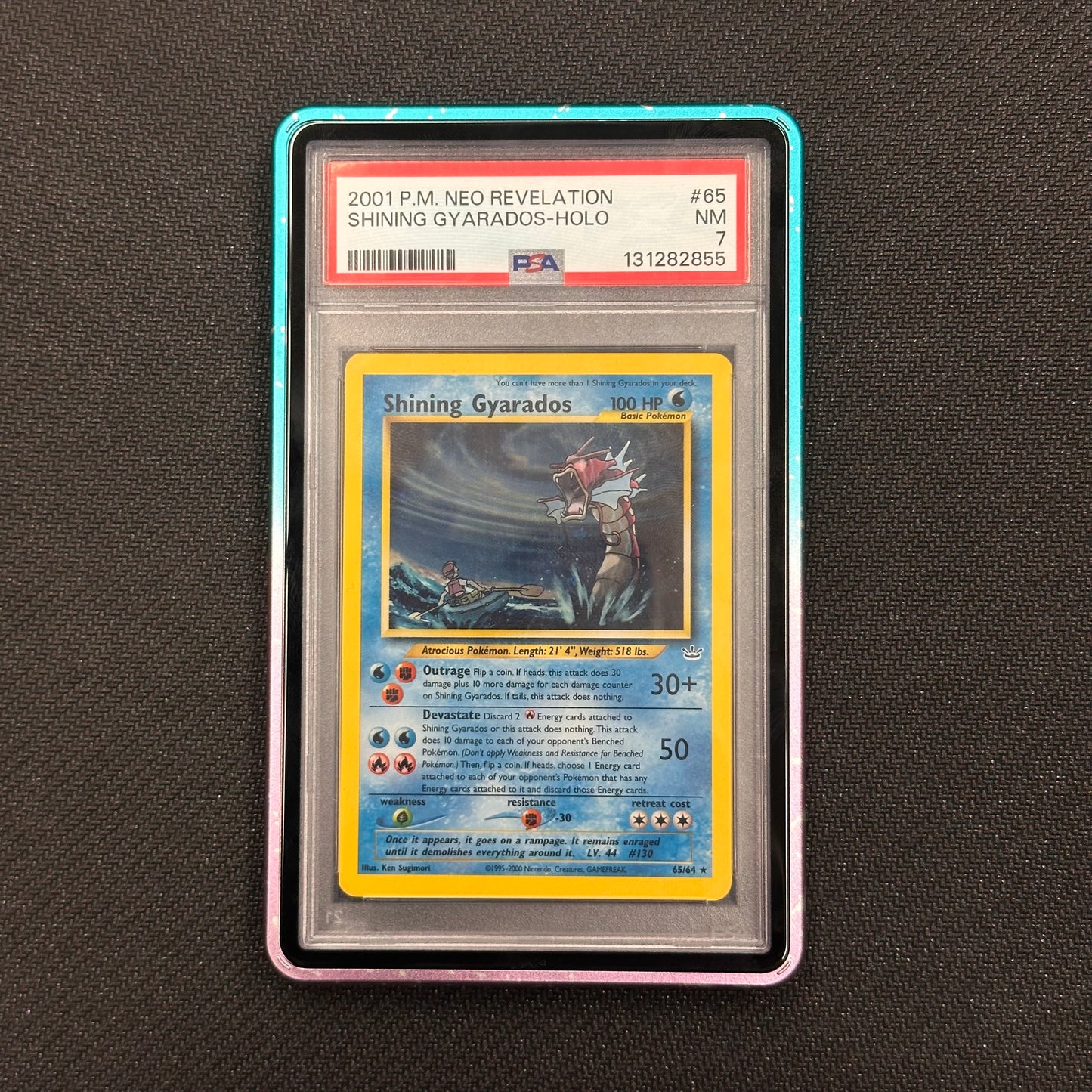 Shining Gyarados trading card in a protective case on a dark textured background