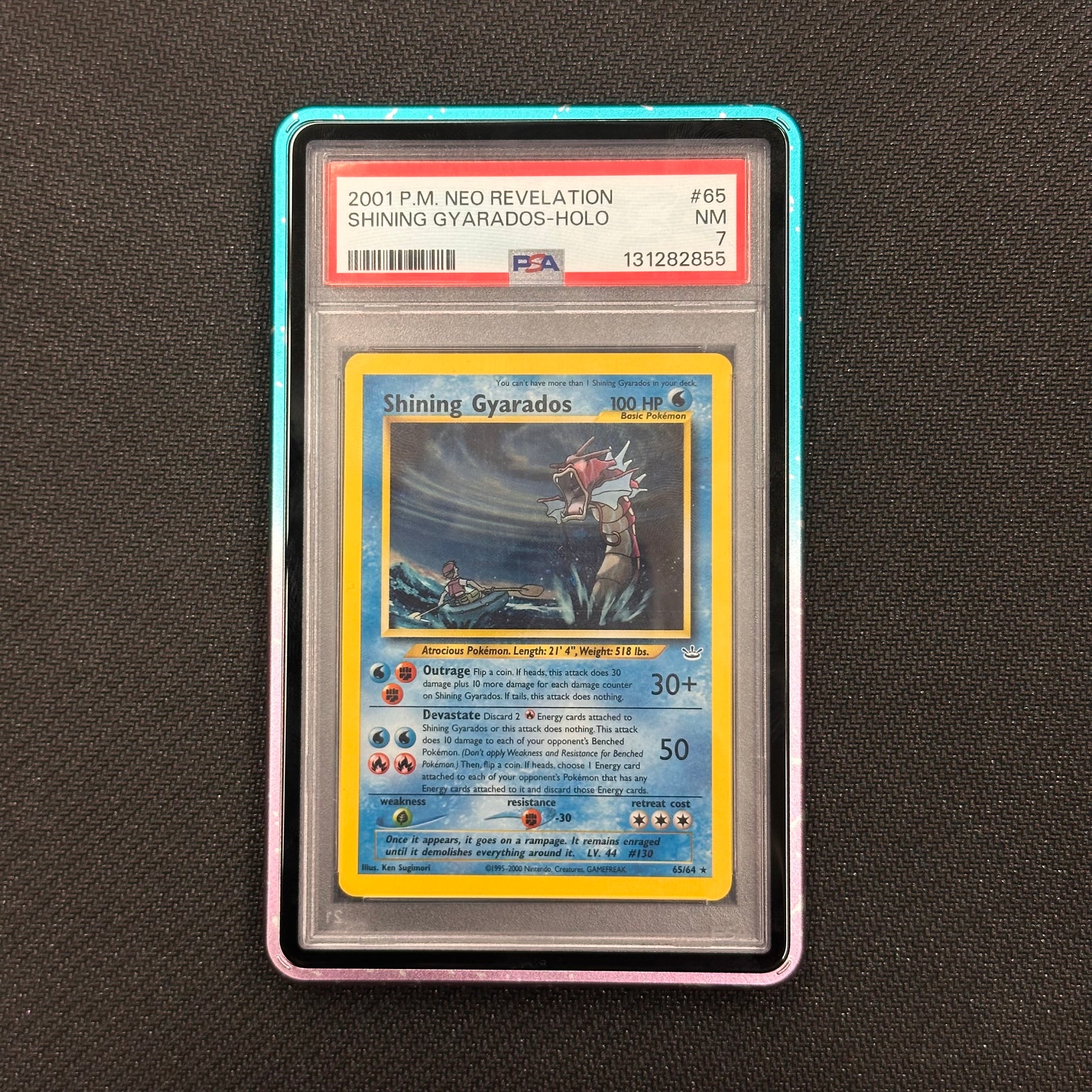 Shining Gyarados trading card in a protective case on a dark textured background