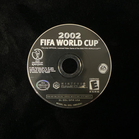 A 2002 FIFA World Cup video game disc for Nintendo GameCube, shown on a black textured background. The disc features white text and logos, including FIFA, Nintendo, and EA.