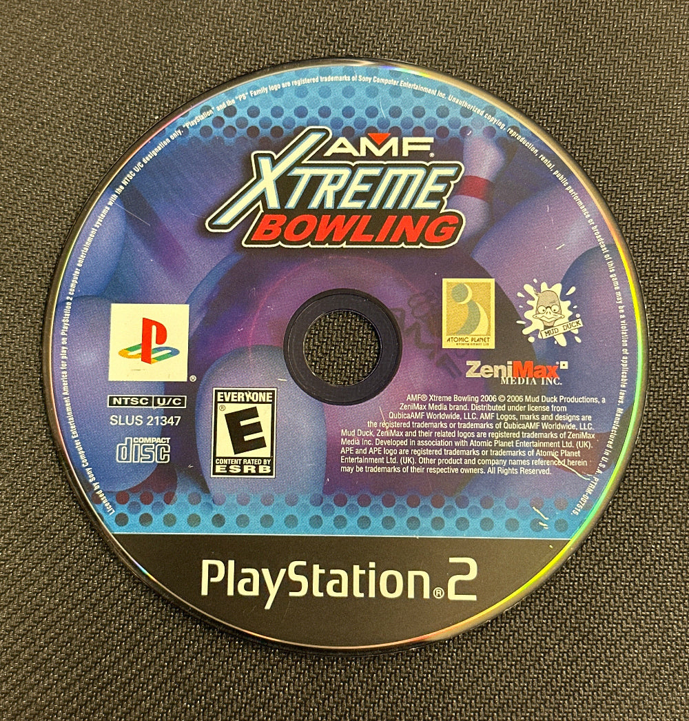PlayStation 2 game disc for 'AMF Xtreme Bowling' on a textured surface