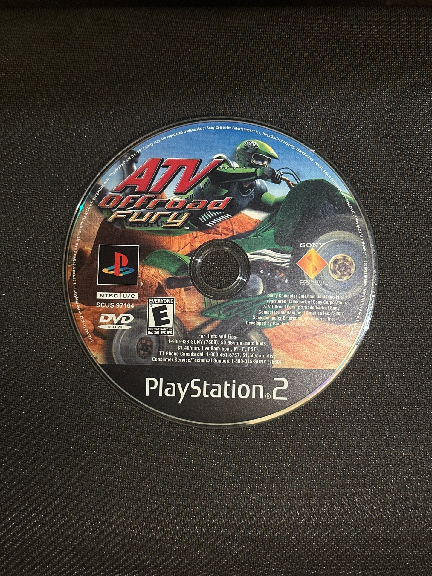 PlayStation 2 game disc on a black textured background