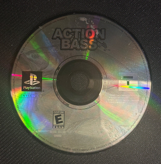 CD with 'Action Bass' branding on a black textured surface