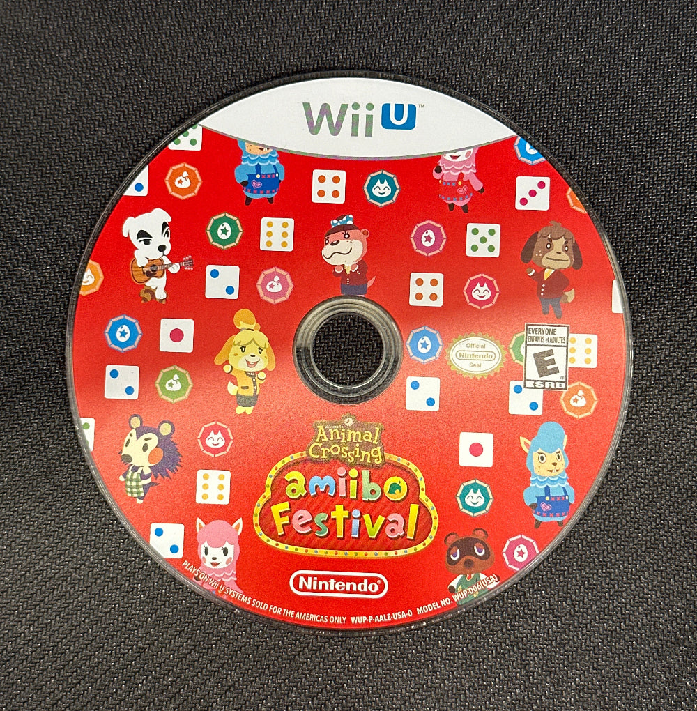 Wii U game disc with 'Animal Crossing: Festiva' on a dark textured surface