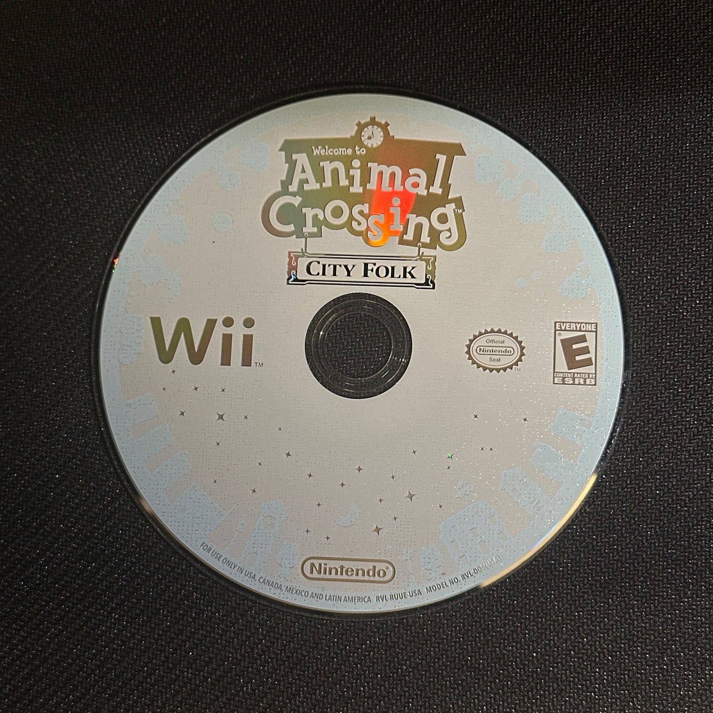 Wii game disc with 'Animal Crossing: City Folk' on a black background