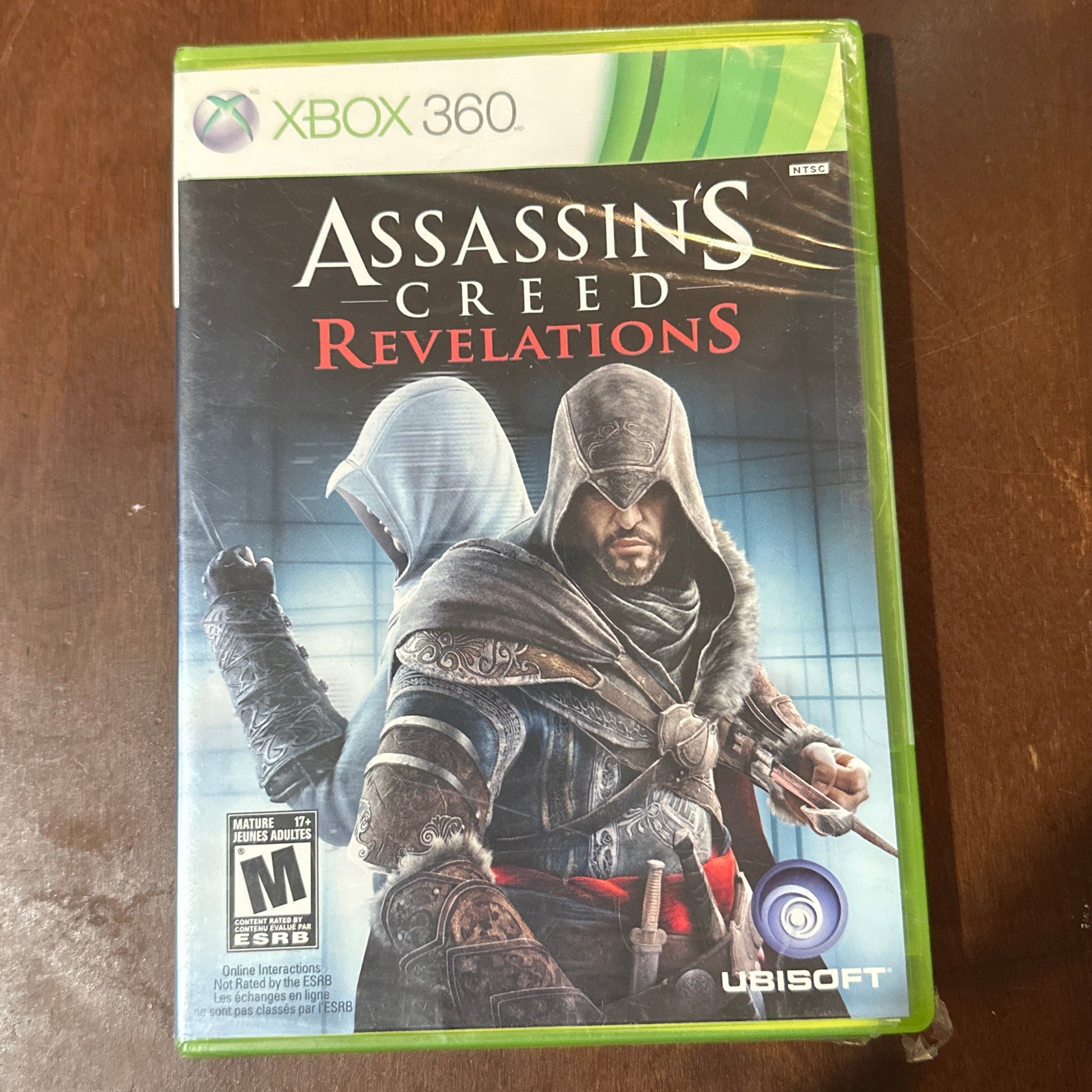 Assassin's Creed Revelations game case on a wooden surface