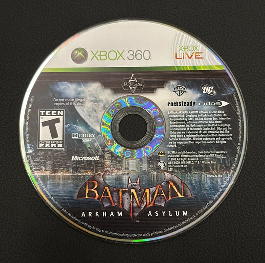 Game disc for 'Batman: Arkham Asylum' on Xbox 360 with branding and graphics.