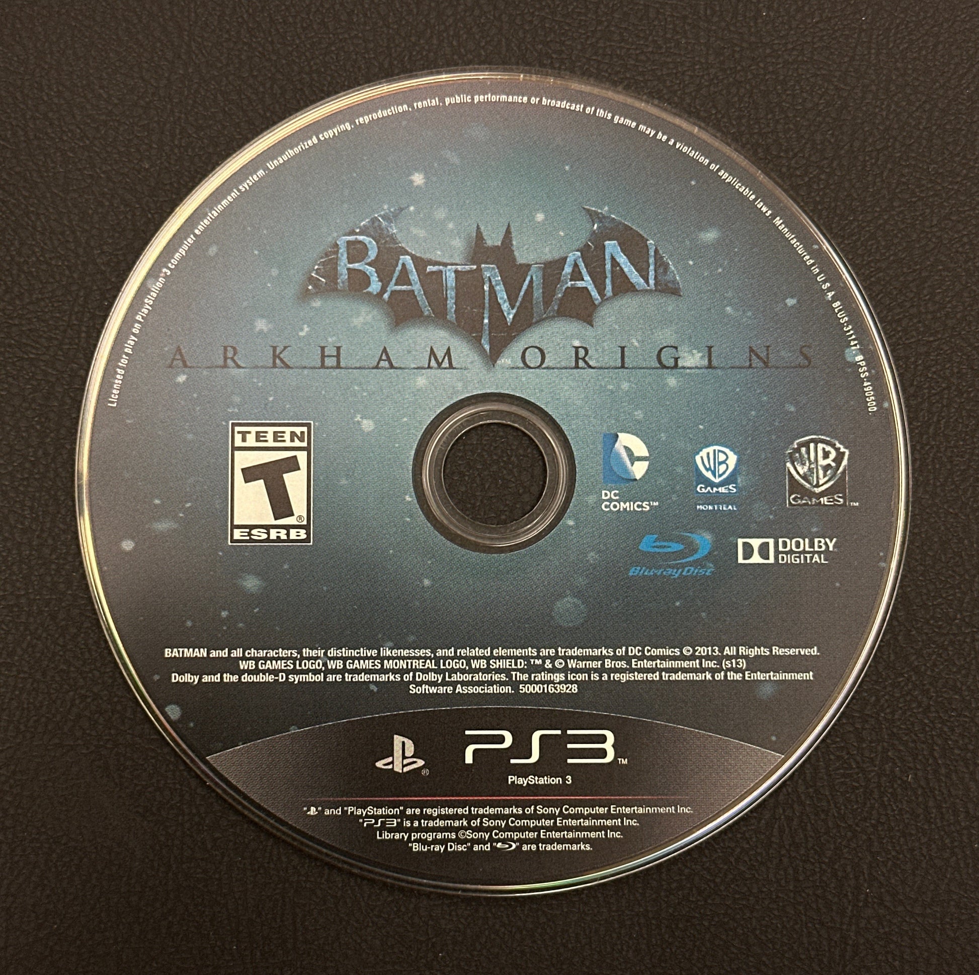 Batman: Arkham Origins game disc on a black background