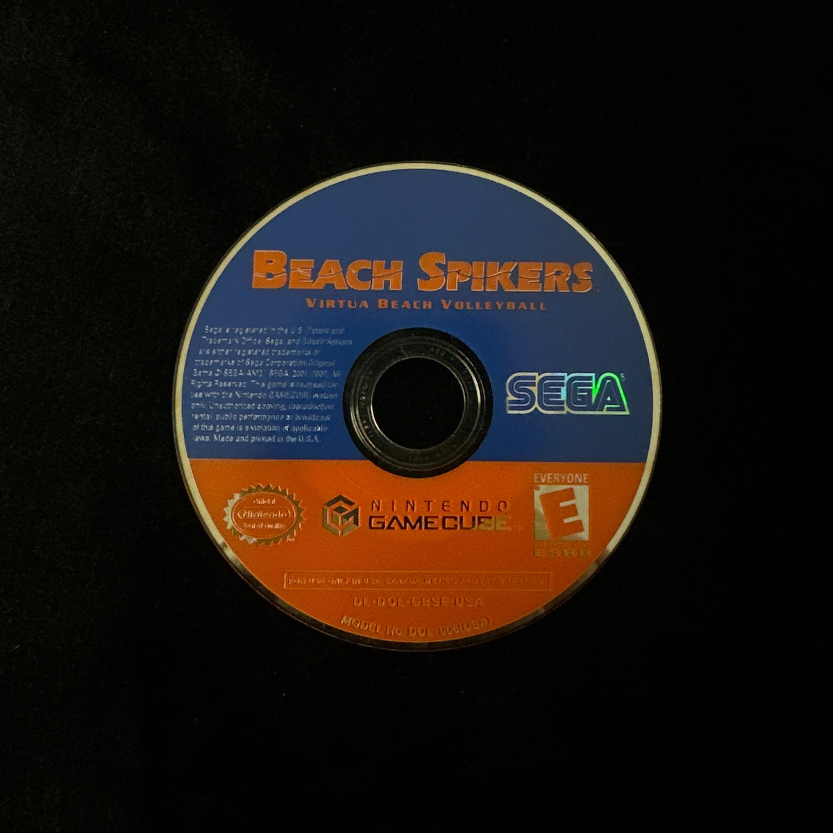 Nintendo GameCube game disc for 'Beach Spikers' featuring a blue and orange label with the SEGA logo, photographed on a black background.