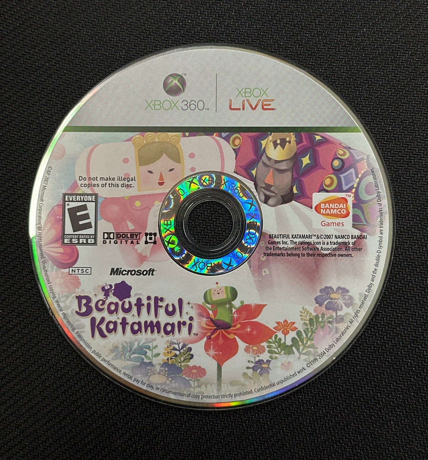 Game disc for 'Beautiful Katamari' on a black background