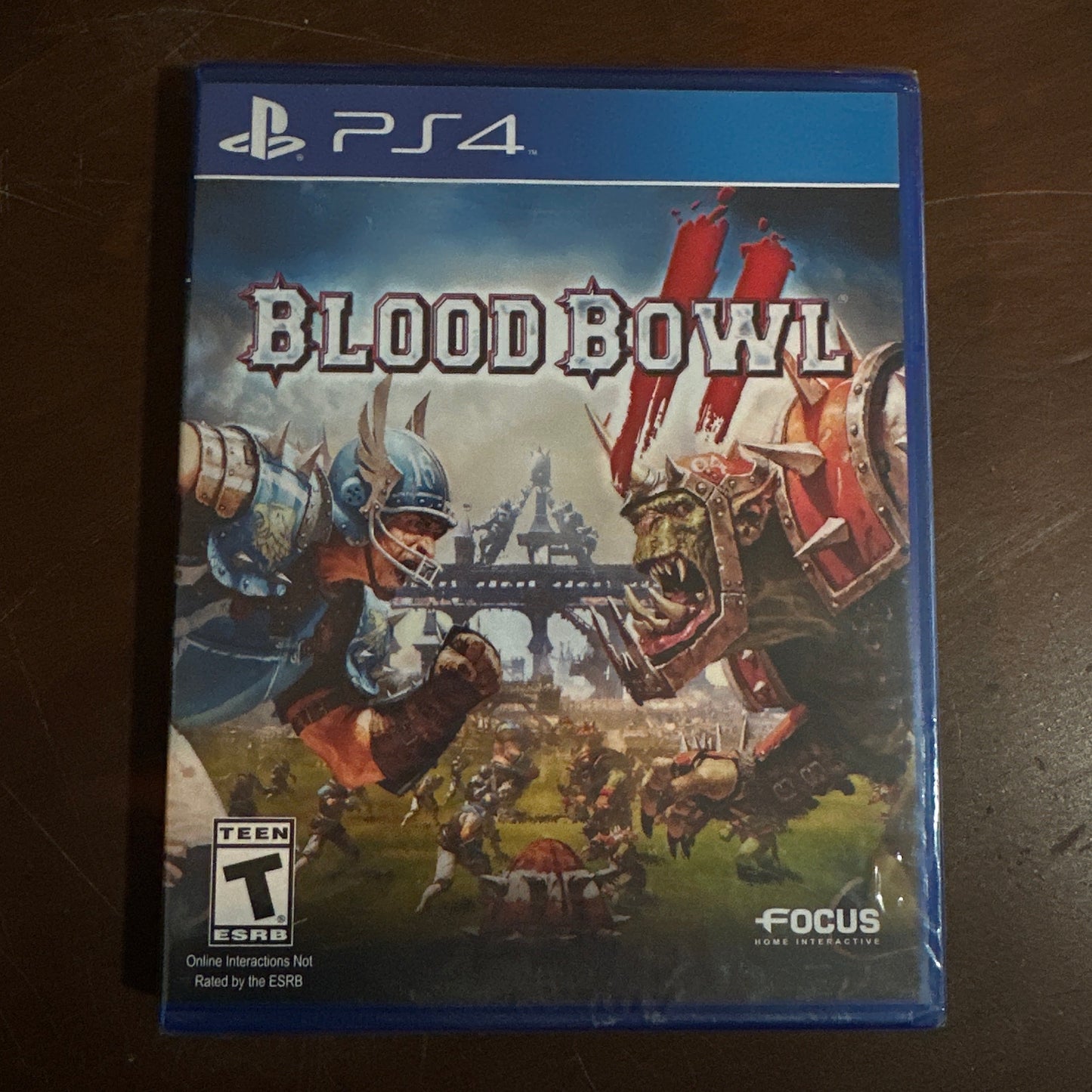 Game case for 'Blood Bowl 2' on a dark surface