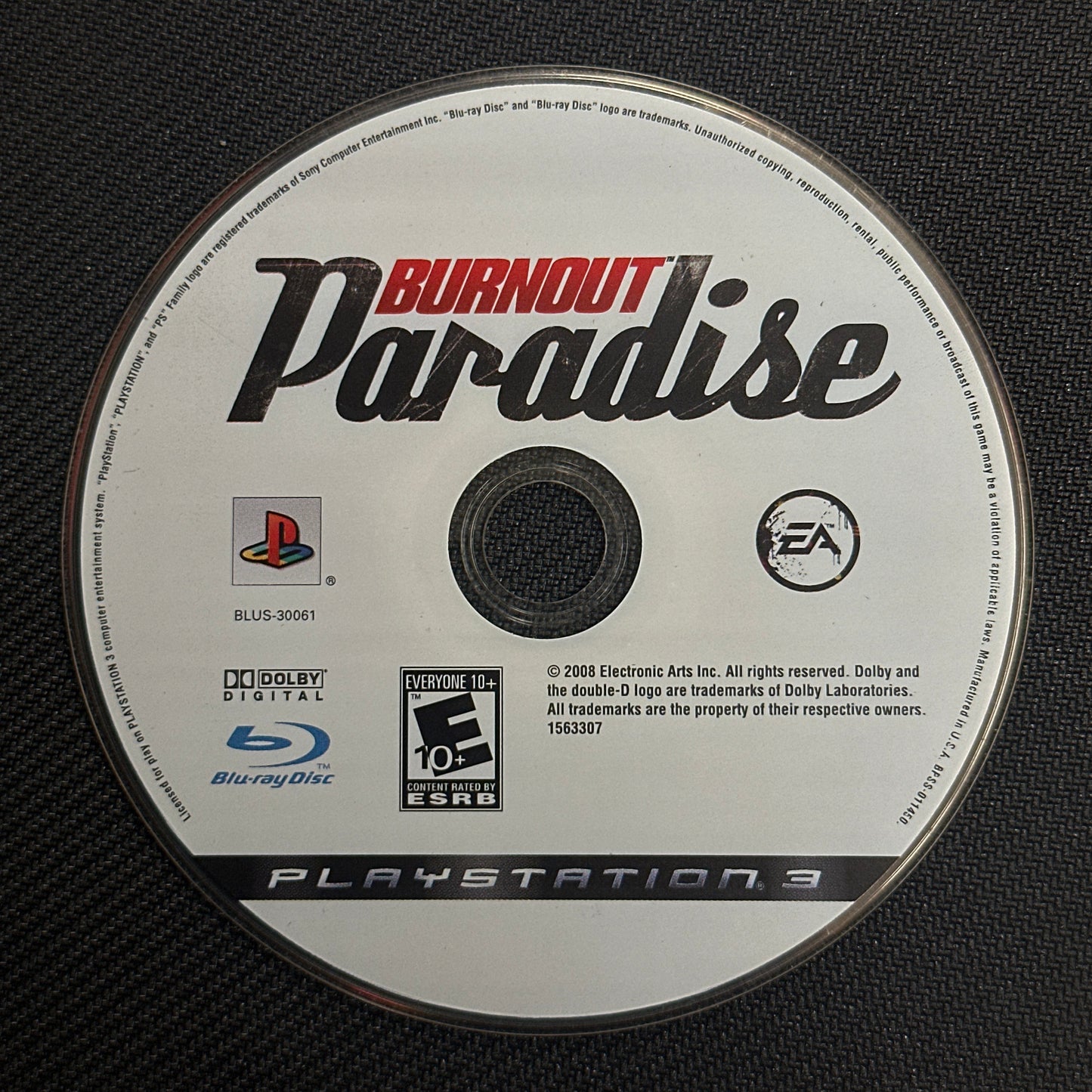 Burnout Paradise PlayStation 3 game disc on a black textured background