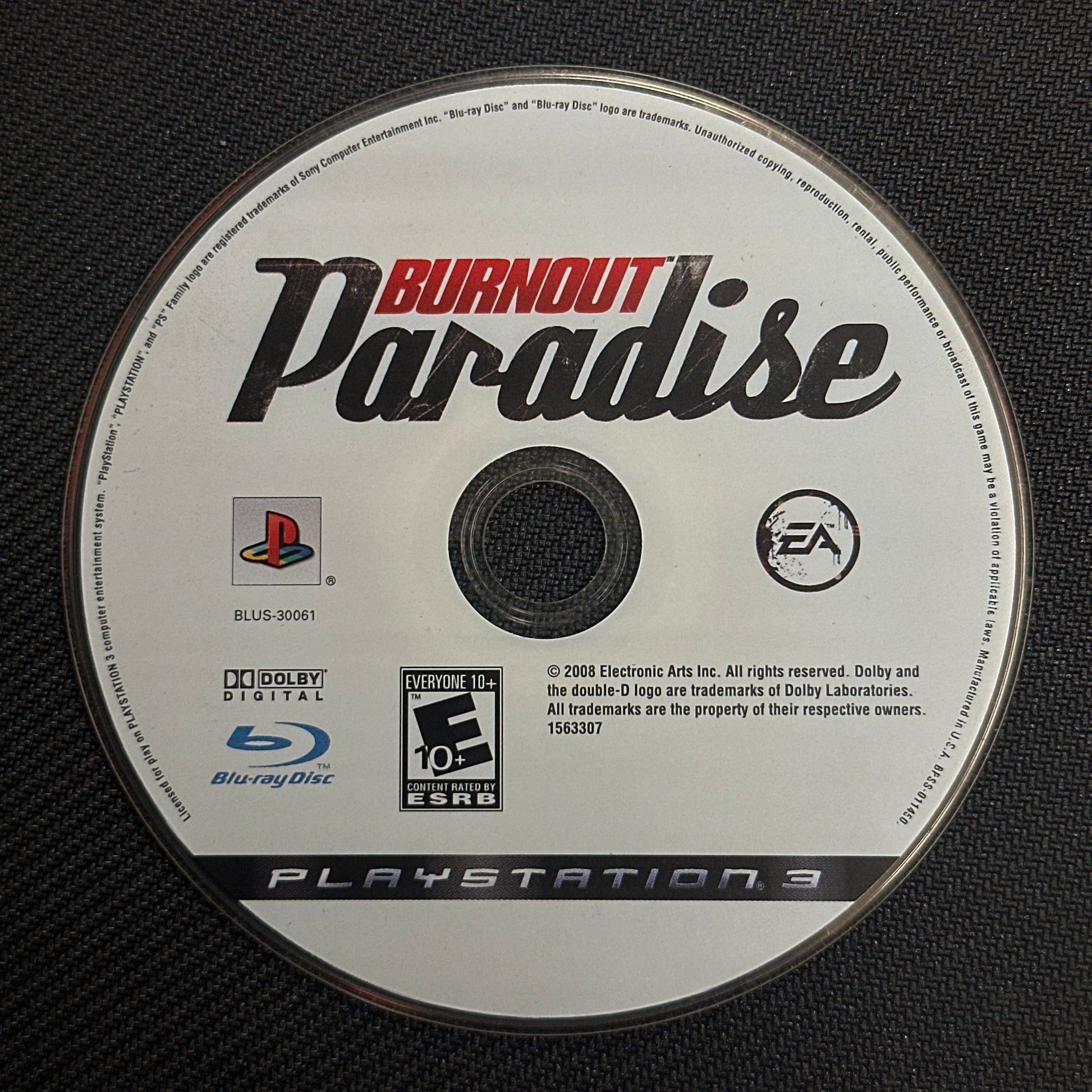 Burnout Paradise PlayStation 3 game disc on a black textured background
