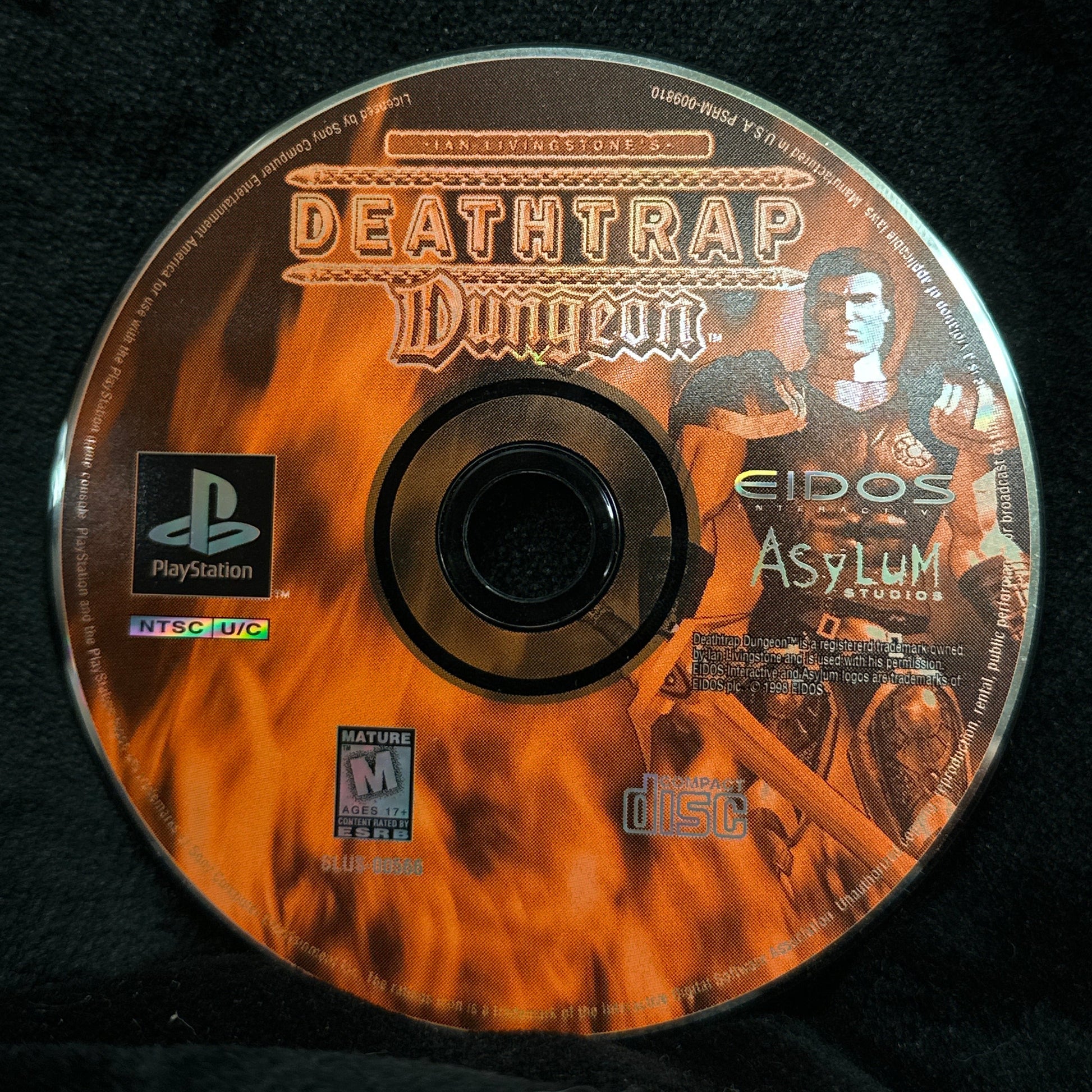 Game disc with 'Deathtrap Dungeon' branding on a black background